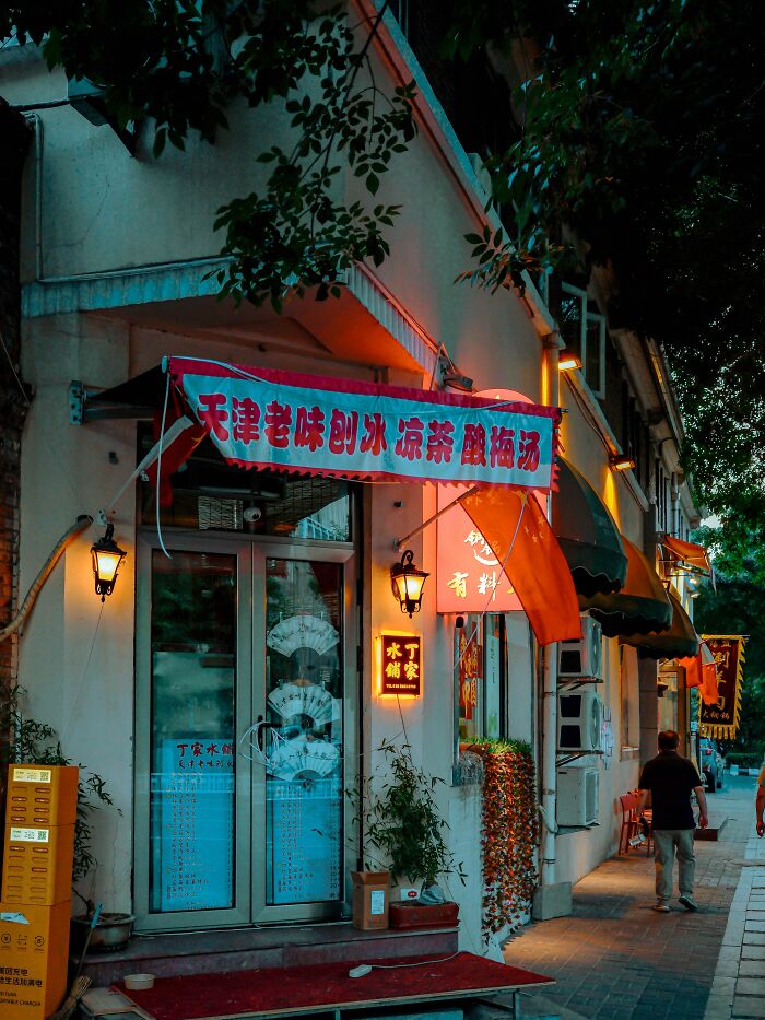An illuminated building with Chinese signs at dusk, reflecting health inspection standards in places.