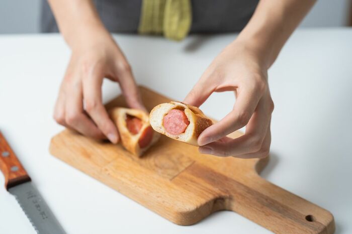 A person holding a cut pigs in a blanket, an example of ridiculous problems HR deals with.