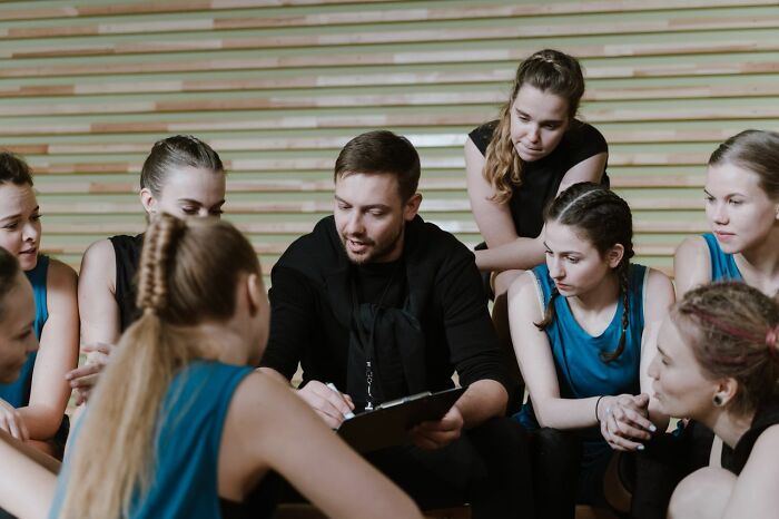 A coach discussing with a group of female athletes, their instincts telling them to get away from creeps.