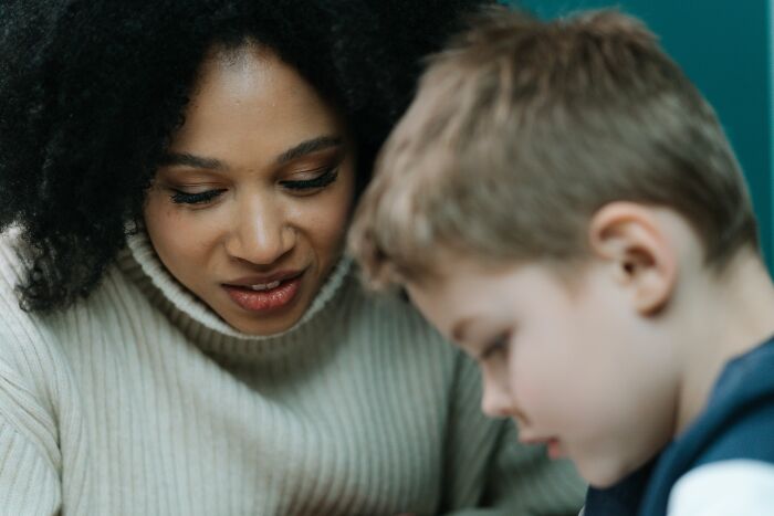 A parent and child looking down, perhaps in a moment of playful terror or shared discovery, lights on.