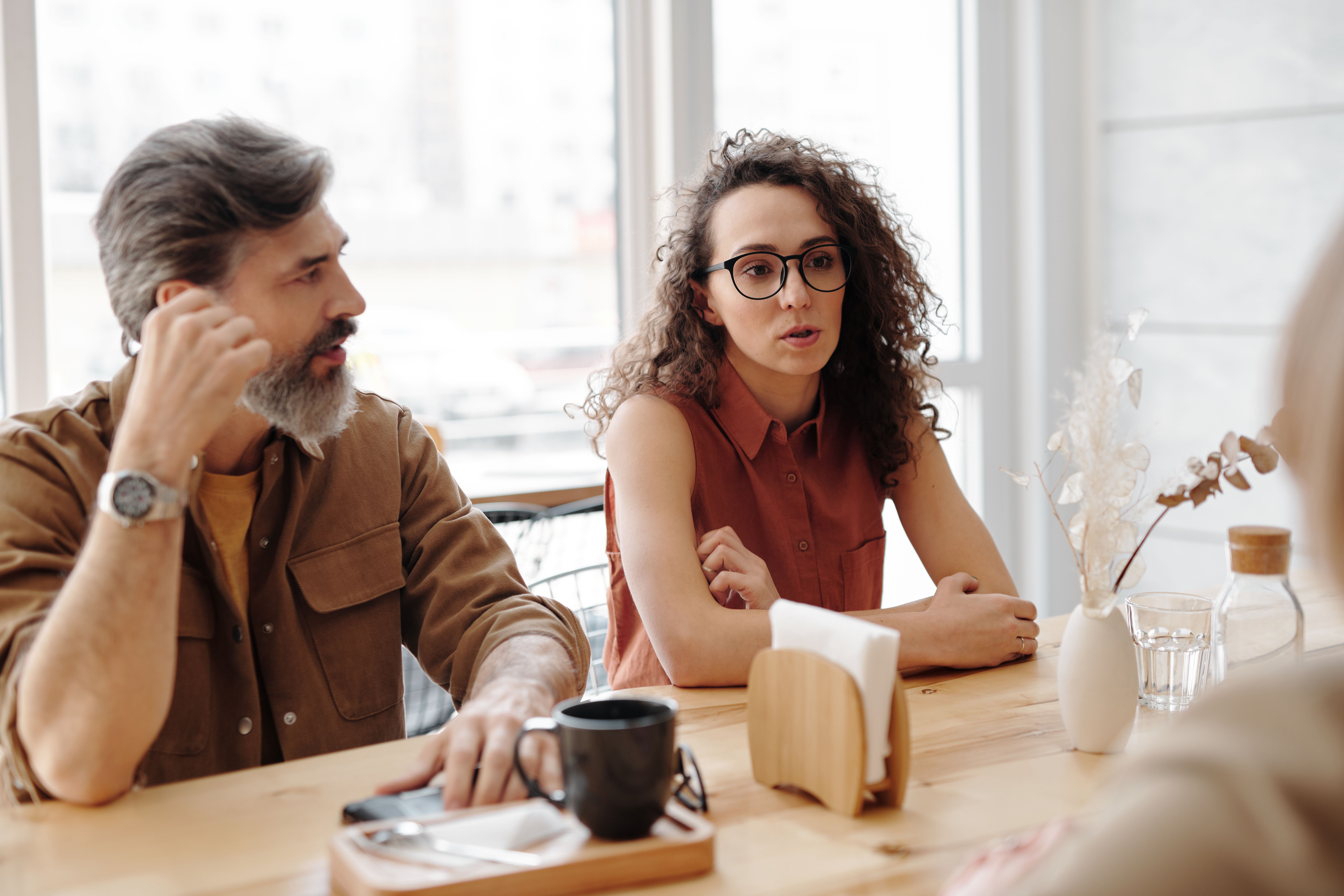 Woman in glasses discussing the aunt's mistake with a man.