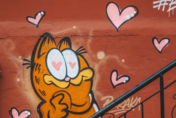 A vibrant Garfield graffiti with hearts, representing Saturday morning cartoon charm and nostalgic questions. A vibrant Garfield graffiti with hearts, representing Saturday morning cartoon charm and nostalgic questions.