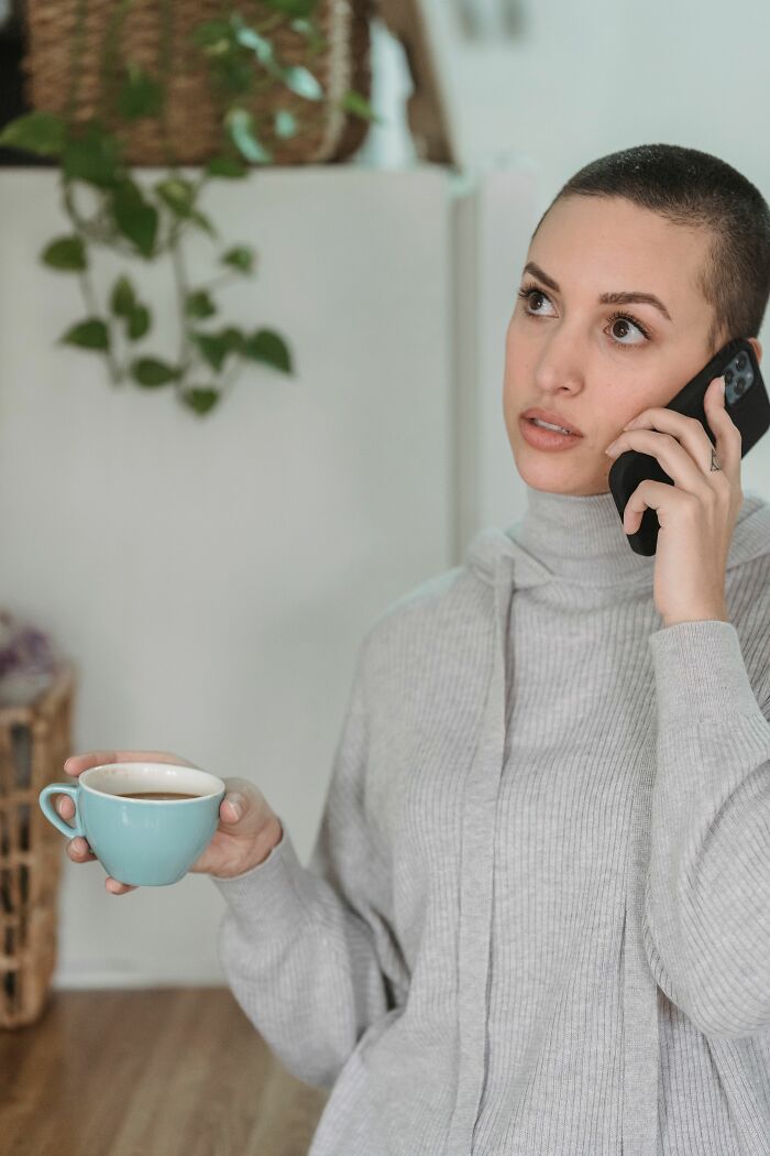 A woman on the phone holding a coffee cup, considering why women changed their minds about 'perfect' guys.