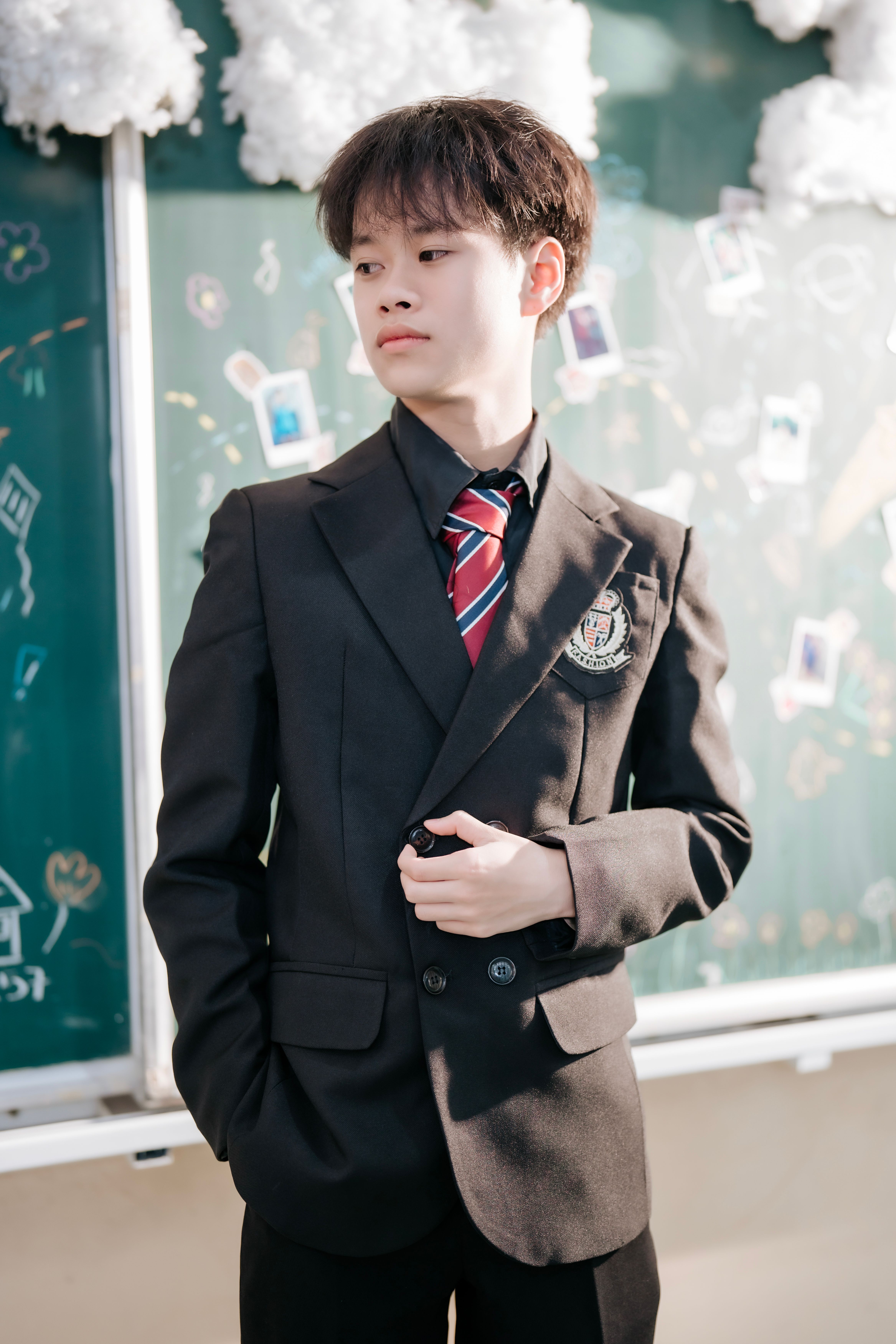 A teenage boy in a school uniform, looking pensive, representing how sexist remarks can backfire. A teenage boy in a school uniform, looking pensive, representing how sexist remarks can backfire.
