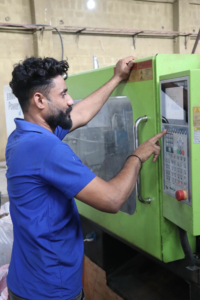 Worker operating machinery in a factory, highlighting the industry secrets of manual labor jobs.