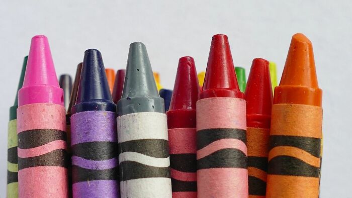 A close-up of a colorful collection of crayons, an image that evokes childhood and stereotypically white phrases.