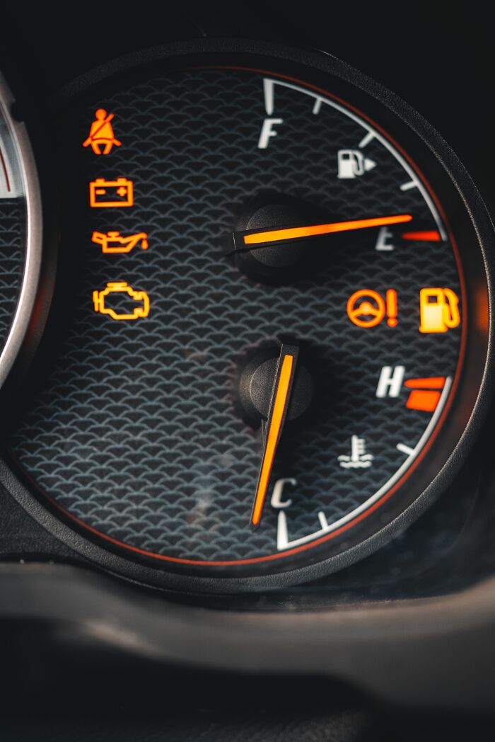 A car dashboard with warning lights, highlighting small cheating red flags or signs of neglect.