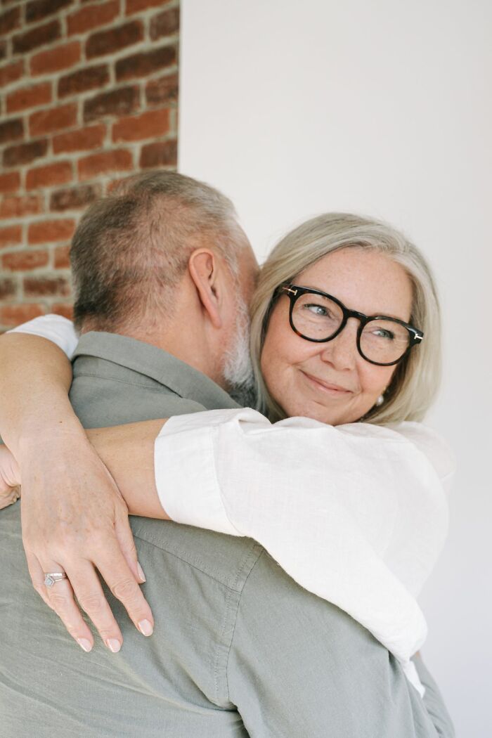 An older couple hugging, showing a calm moment amidst the ridiculous problems HR deals with.