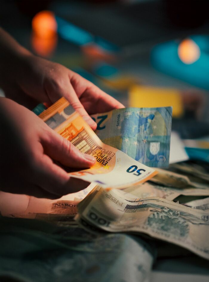 Hands counting money, potentially related to financial issues with entitled friends.