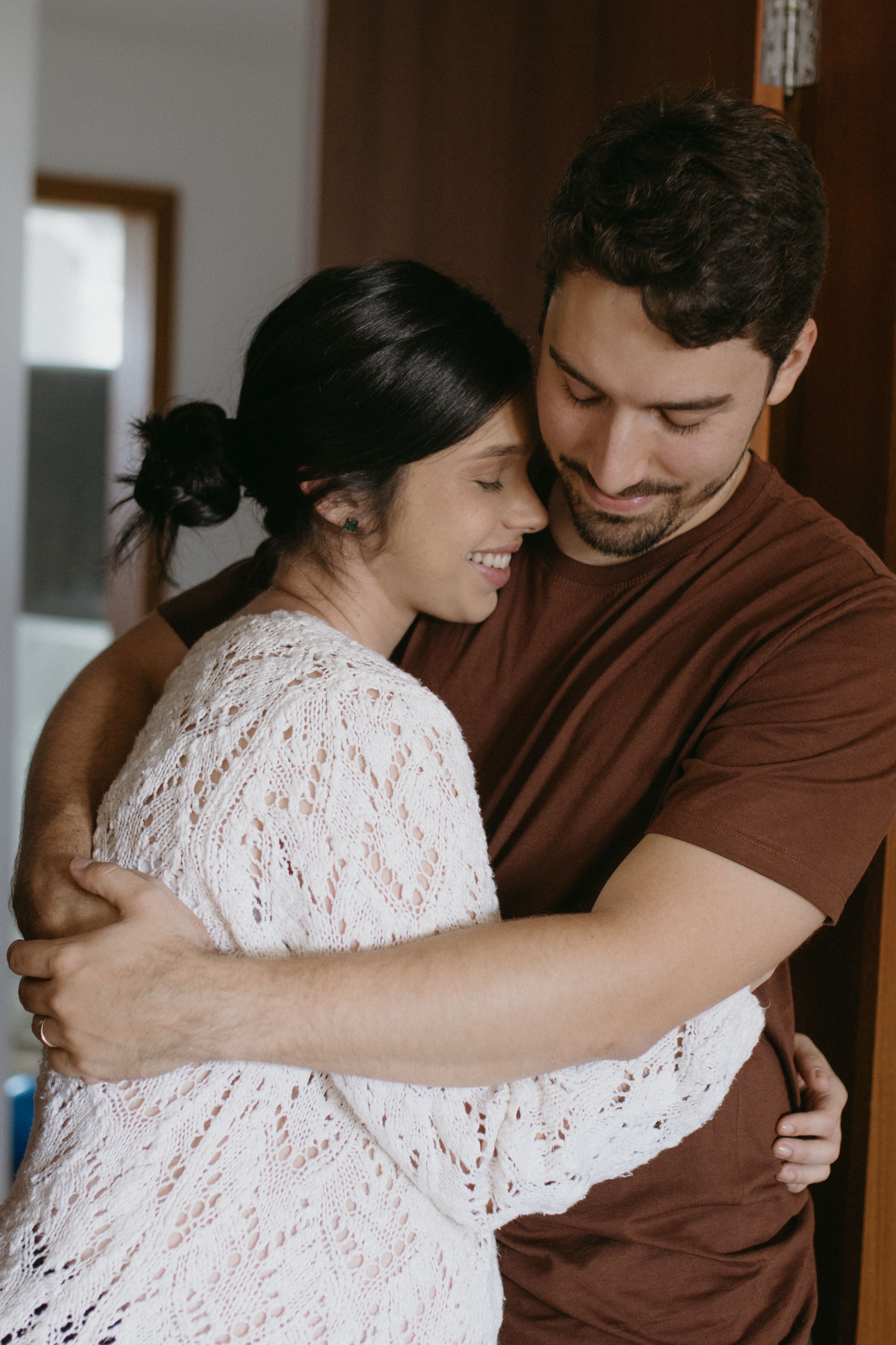 A happy couple embraces, celebrating buying their dream home. A happy couple embraces, celebrating buying their dream home.