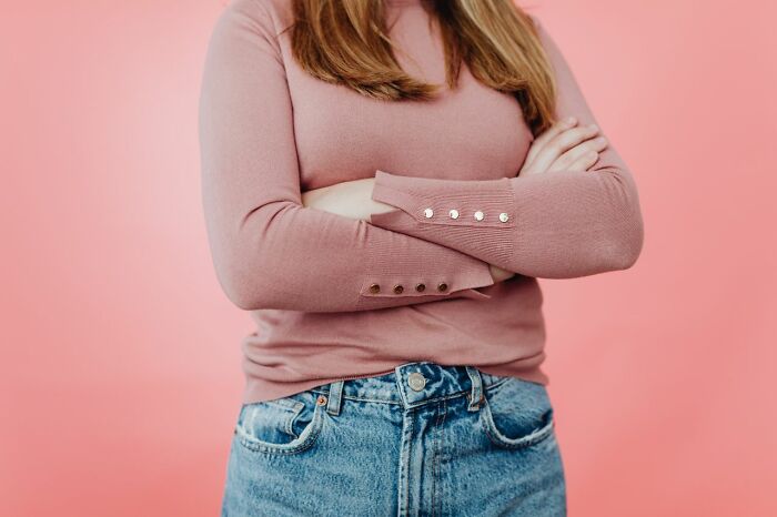 A person with arms crossed, symbolizing a feeling often associated with entitled friends.