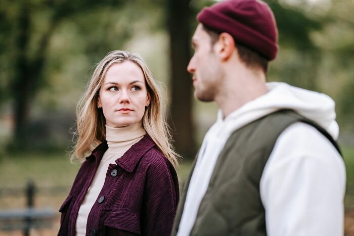 A young couple looking at each other outdoors, depicting things to know before getting married.