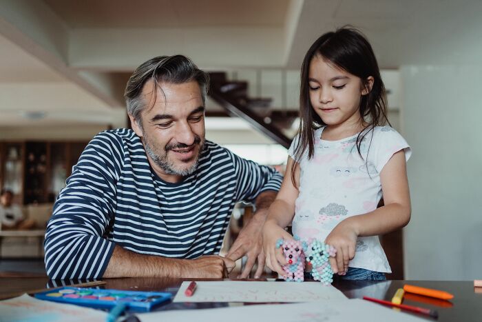 A father and daughter play together, navigating the twists and turns of family life with joy.