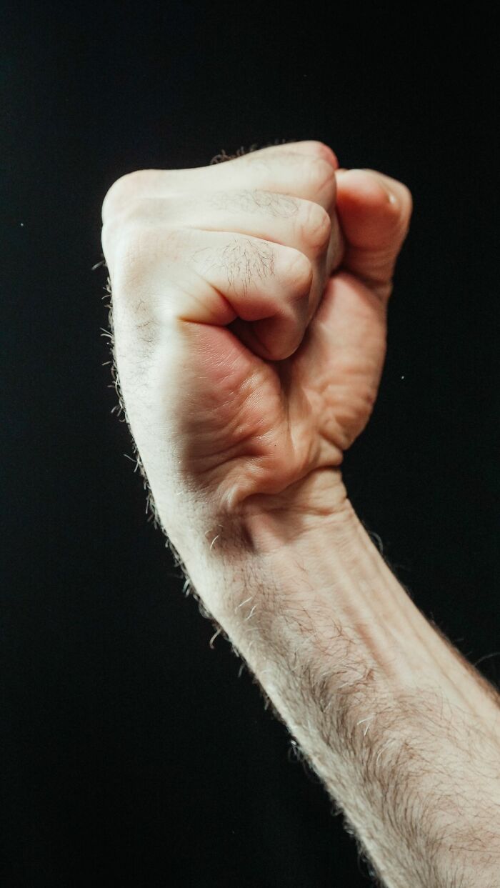 A clenched fist, representing the impactful nature of stereotypically white phrases that crack people up.