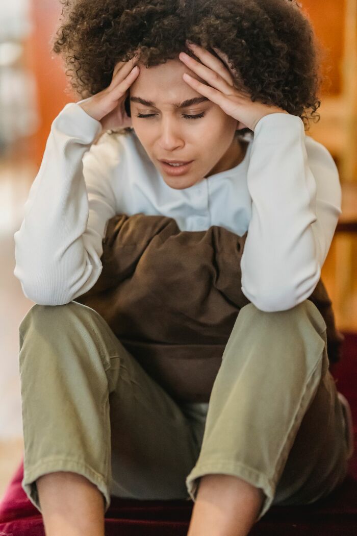A woman with a headache, possibly from damaging secrets people weren't supposed to know.