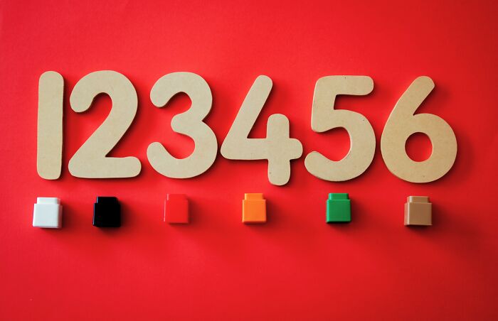 A visual brain workout with numbers 1-6 in wooden cutouts and corresponding colored blocks on a red background.