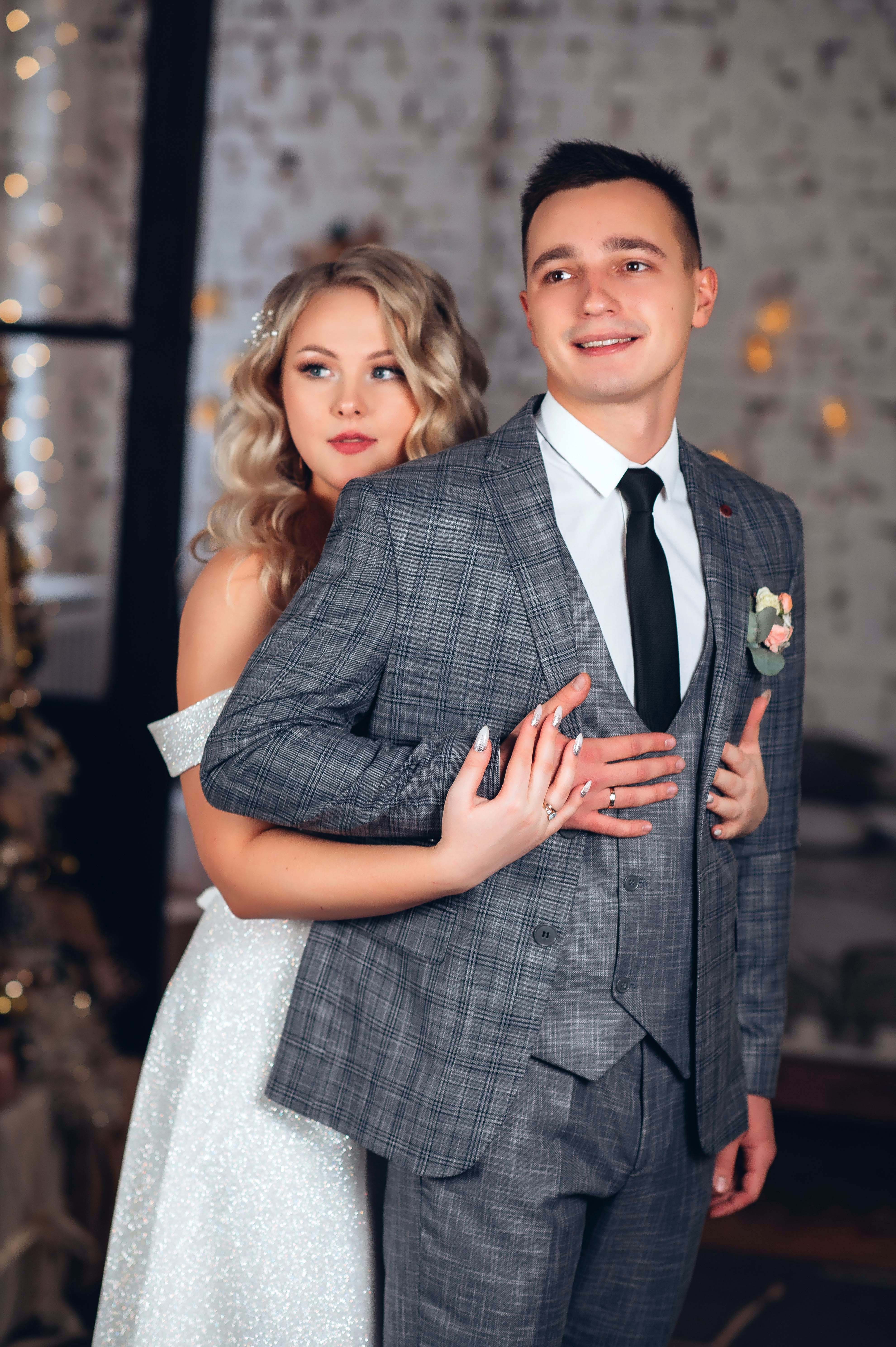 A beautiful bride embraces her groom, both smiling, reflecting on the scary fixation and unsettling turn of events a year later.