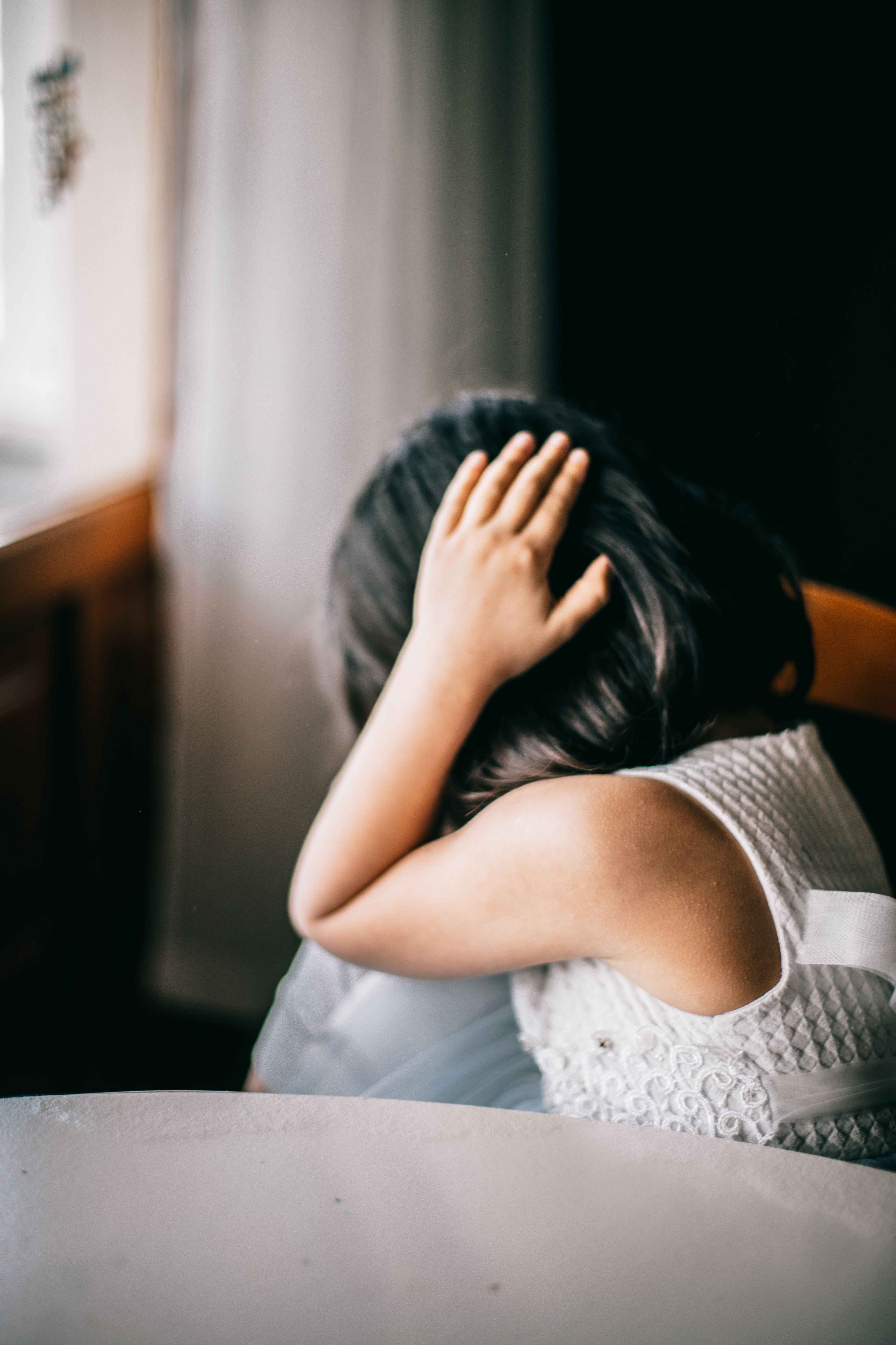 A young girl in a white dress crying, experiencing a dog owner's worst nightmare. A young girl in a white dress crying, experiencing a dog owner's worst nightmare.