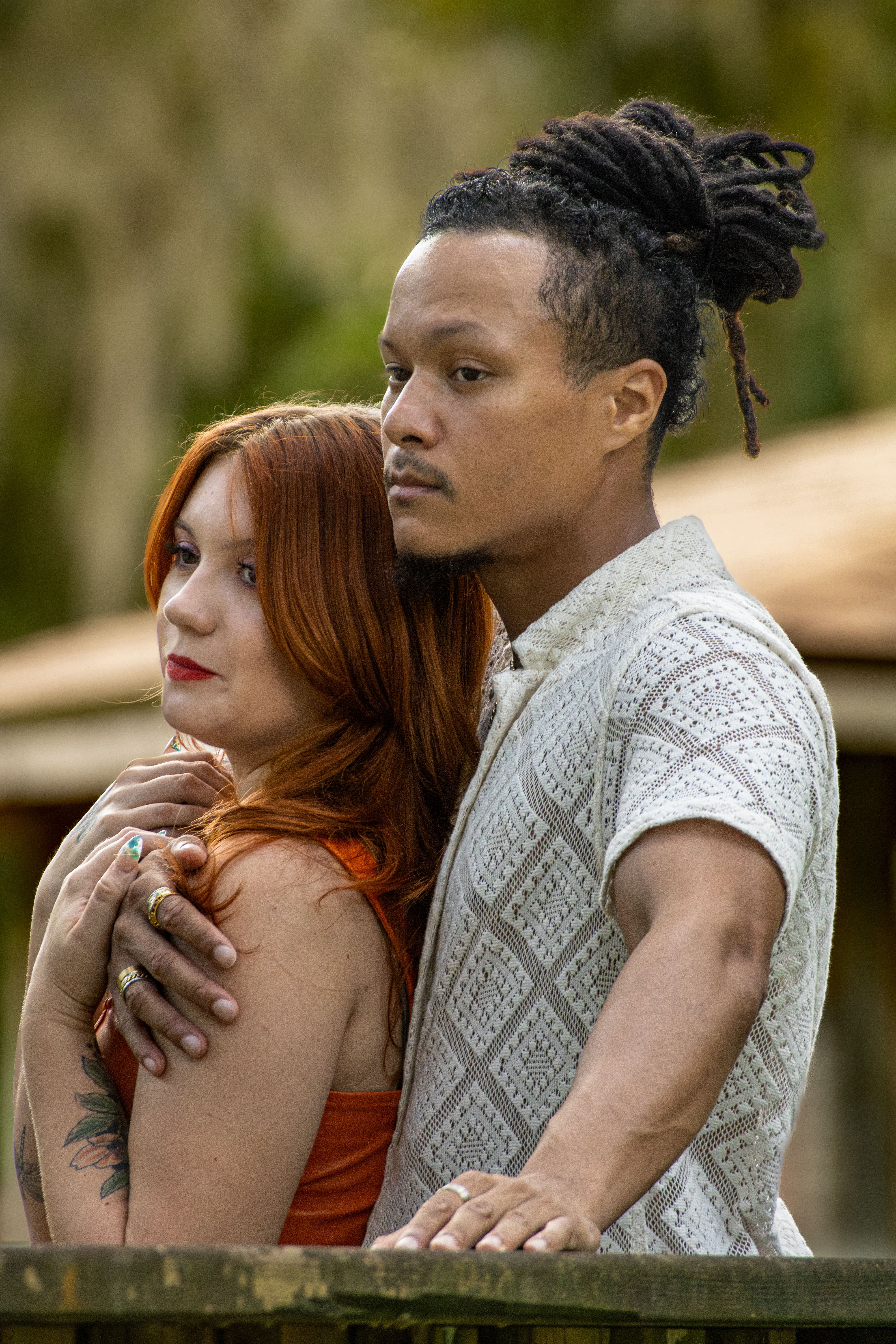 A man with dreadlocks and a red-haired woman looking into the distance, unrelated to the Old Karen accusation. A man with dreadlocks and a red-haired woman looking into the distance, unrelated to the Old Karen accusation.