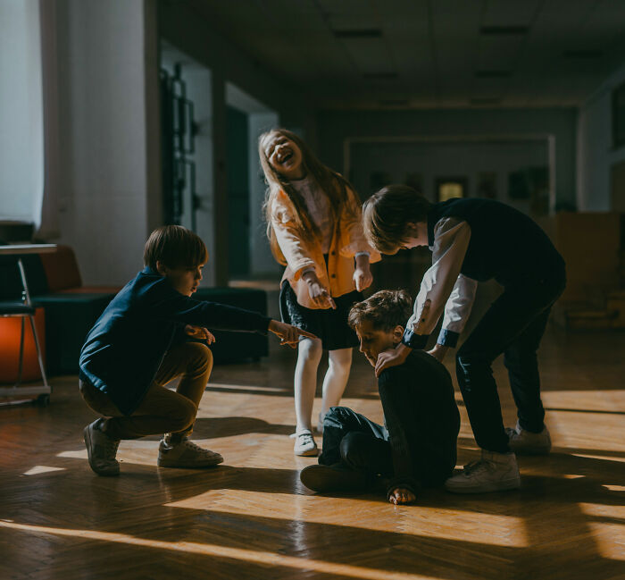 Children mistreating classmate, highlighting the importance of a psychologist's reaction to such bullying incidents. Children mistreating classmate, highlighting the importance of a psychologist's reaction to such bullying incidents.
