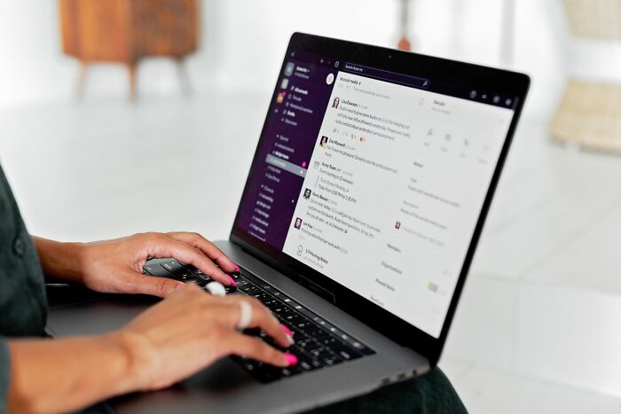 Someone typing on a laptop, using communication software, revealing behind the scenes company operations.