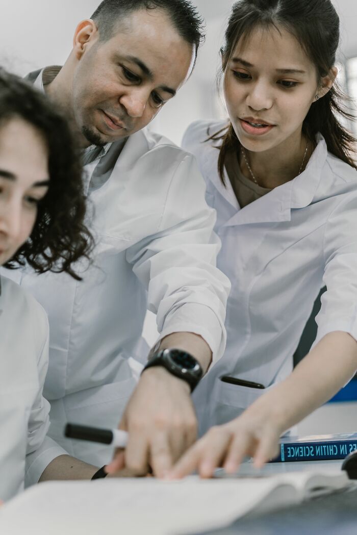 Scientists in lab coats collaborating, highlighting industry secrets that changed jobs.