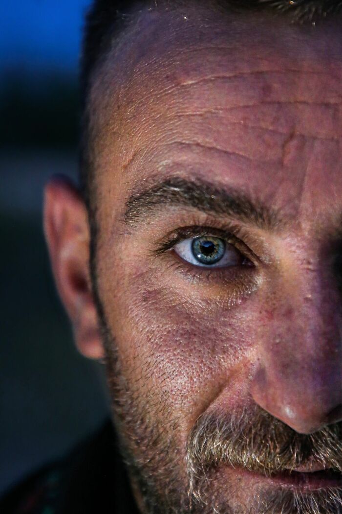 A close-up of a man's intense blue eye, hinting at encounters with creeps and deeply evil situations.