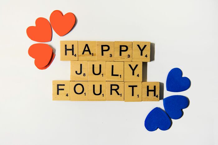Scrabble tiles spelling Happy Fourth Of July with red and blue hearts. Celebrate U.S. knowledge and independence. Scrabble tiles spelling Happy Fourth Of July with red and blue hearts. Celebrate U.S. knowledge and independence.