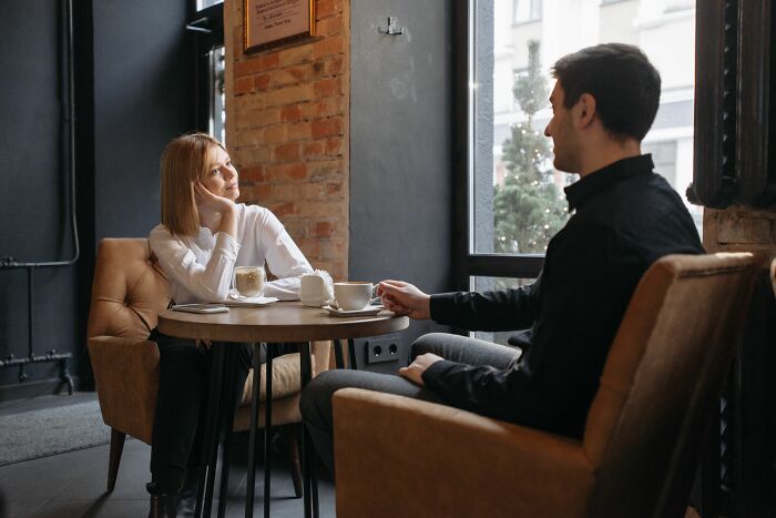 A couple on a date at a cafe, discussing why women changed their minds about perfect guys.