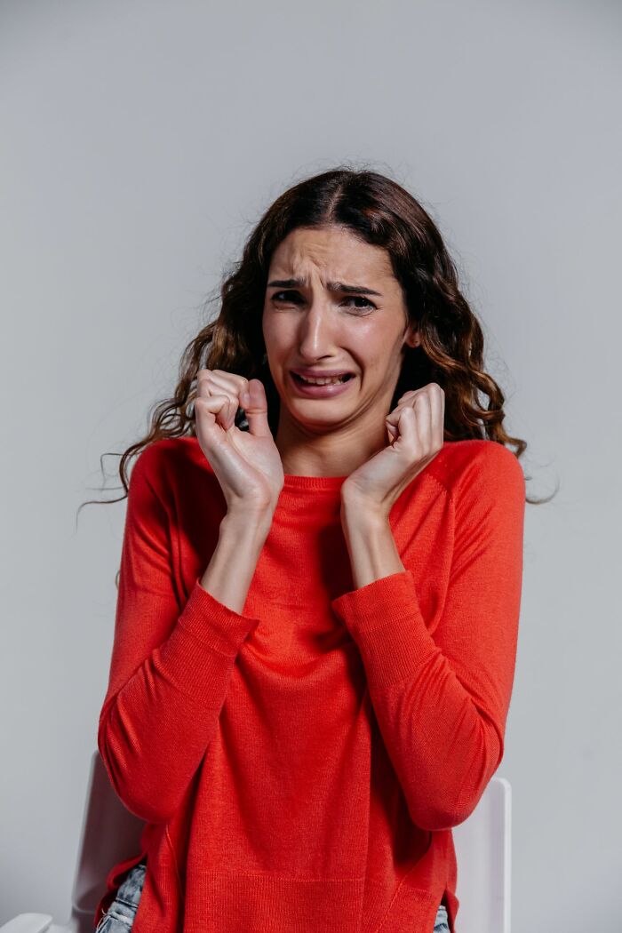 Woman looking scared and distressed, trusting her instincts about deeply evil creeps.