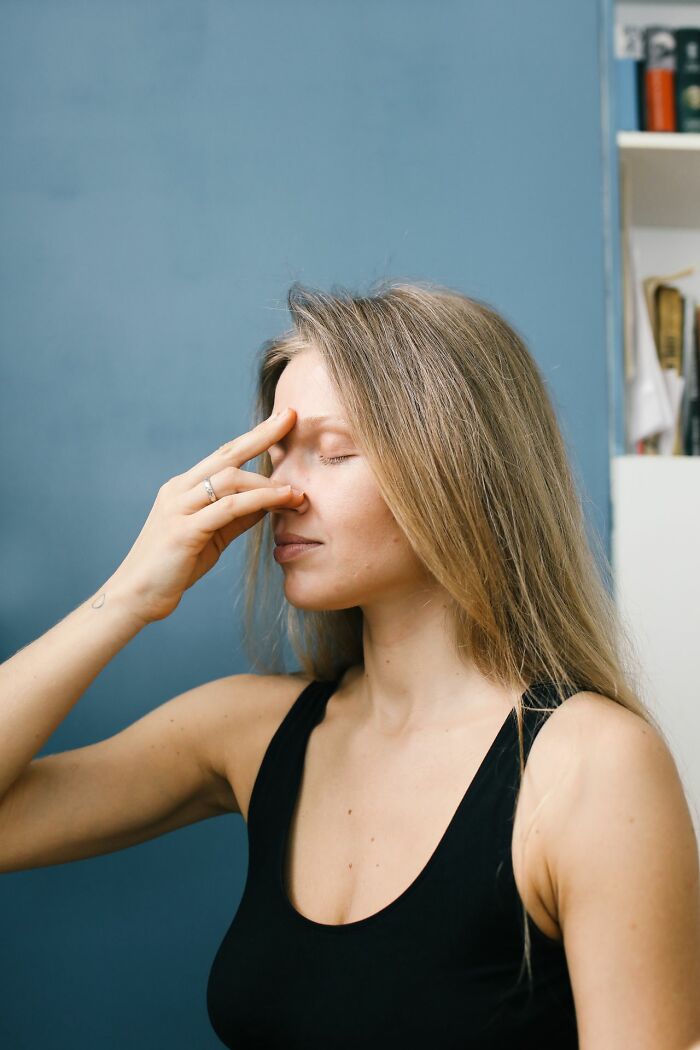 Woman performing yoga breathwork, escaping ridiculous HR problems caused by adults.