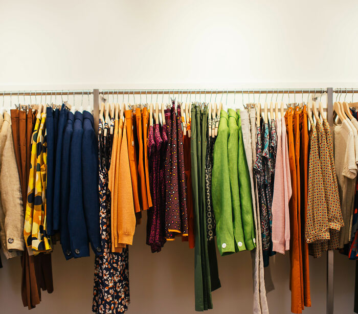 A rack filled with various colorful clothing items in a retail store, showcasing the available clothing selection for plus-size influencer discussion. A rack filled with various colorful clothing items in a retail store, showcasing the available clothing selection for plus-size influencer discussion.