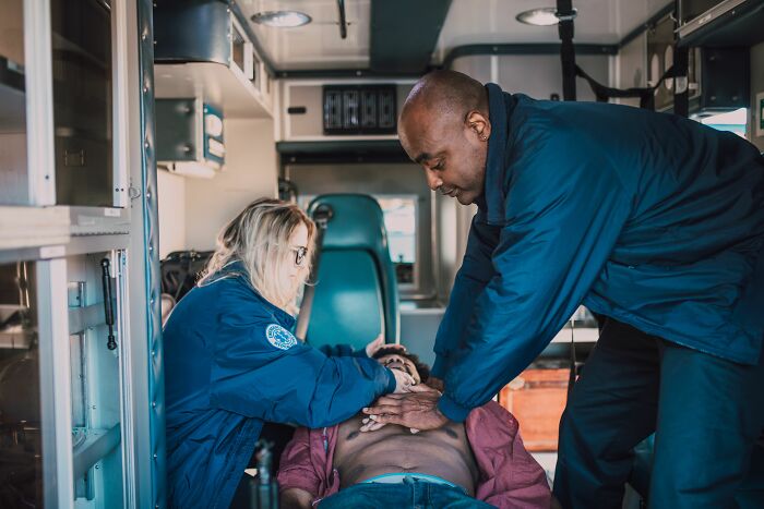 Paramedics performing CPR inside an ambulance, a catastrophic situation that could be linked to pocket dial stories.