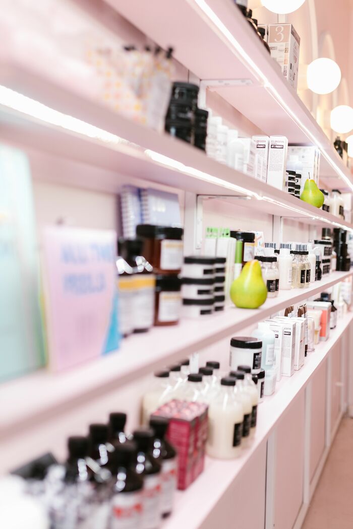 Shelves stocked with various beauty products in a store, revealing the industry secrets of retail jobs.