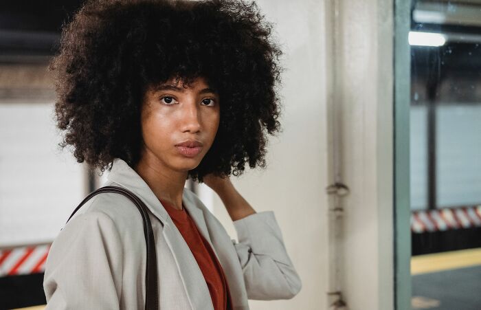A woman with a serious expression, possibly noticing psychological red flags in a situation.