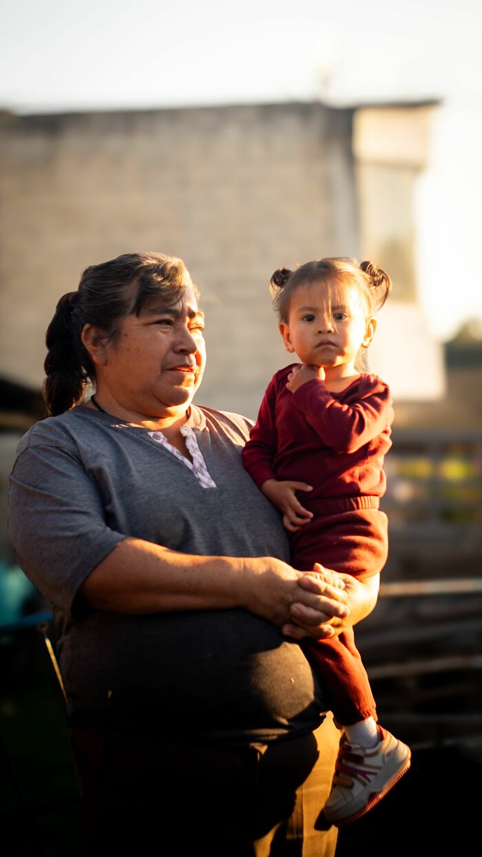 An adult holds a child with a serious expression, portraying a scenario where parents were terrified of their own children.