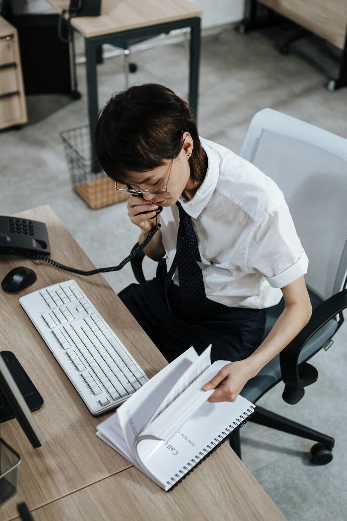 Office worker on the phone, managing company operations and its behind the scenes secrets.