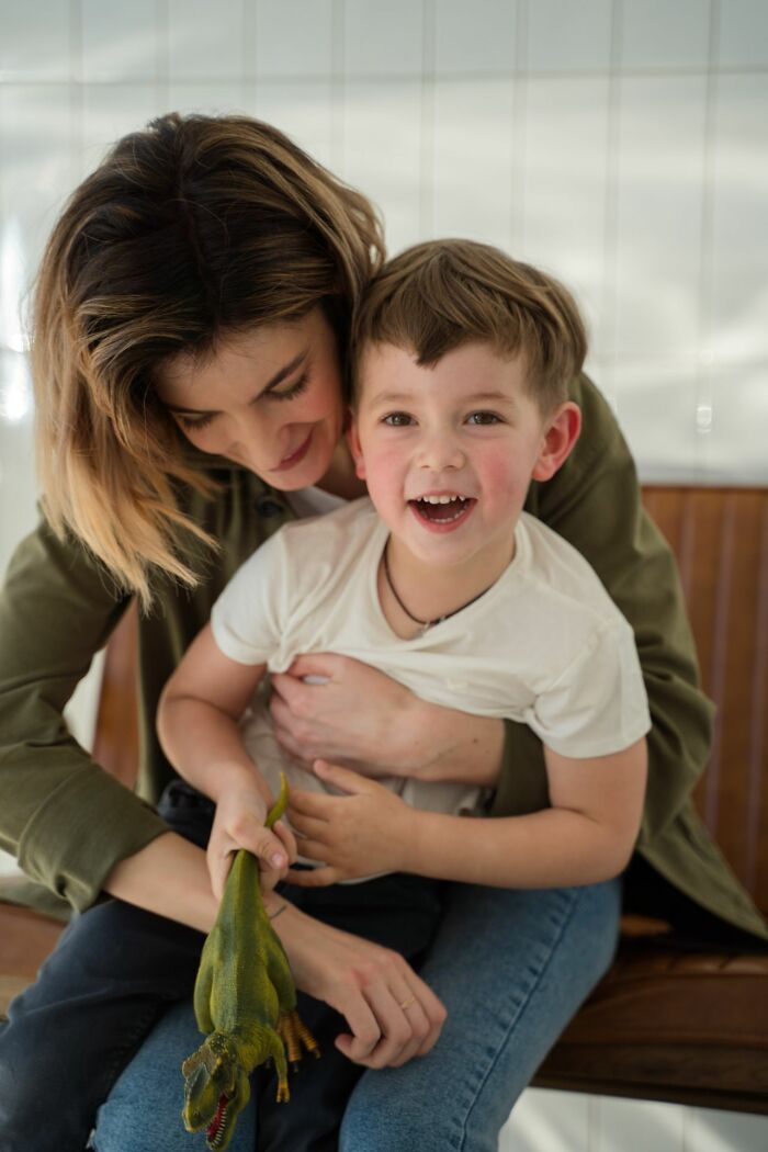 A happy young boy with his mother, unaware of any secrets people weren't supposed to know.