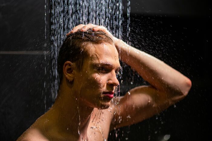 A man showering, a potential small cheating red flag if showering habits change unexpectedly.