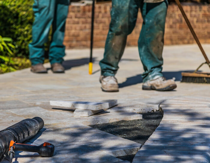 Landscaper works on a new patio installation, getting his revenge after a dispute. Landscaper works on a new patio installation, getting his revenge after a dispute.