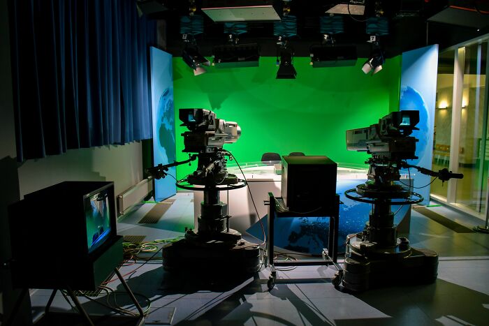 A television studio with a green screen, where industry secrets about broadcast jobs are uncovered.