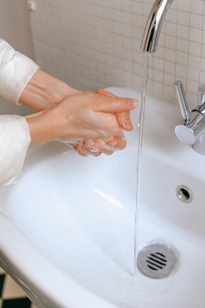 Hands washing with soap under running water in a white sink, symbolizing ways people have lost their lives.