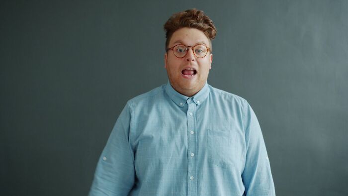 A man with a surprised expression, embodying a stereotypically white phrase that cracks people up.