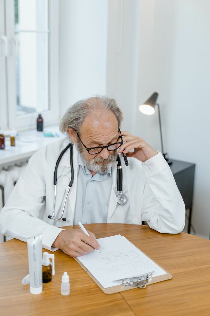 A doctor writing, reflecting on aspects of American habits or healthcare.
