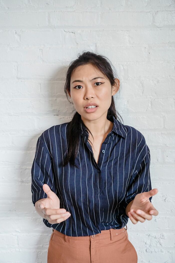 A woman gesturing with her hands, expressing frustration over problems HR has to deal with.