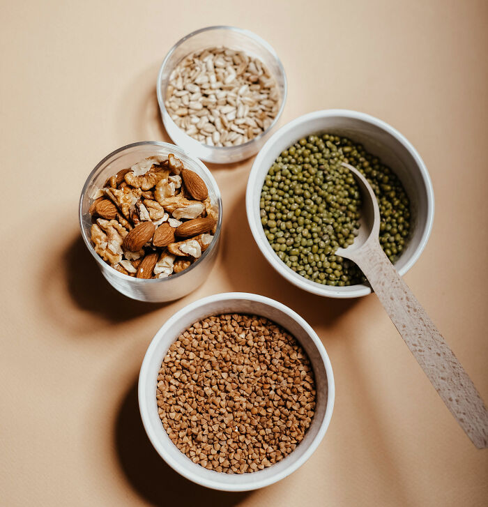 Various healthy ingredients like nuts and seeds, contrasting with unhealthy trendy snack food causing terrifying side effects.