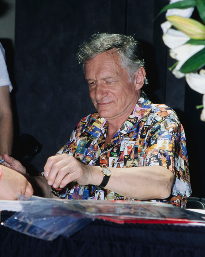 Hugh Hefner, founder of Playboy, signing autographs, showing the brand's history before its makeover. Hugh Hefner, founder of Playboy, signing autographs, showing the brand's history before its makeover.