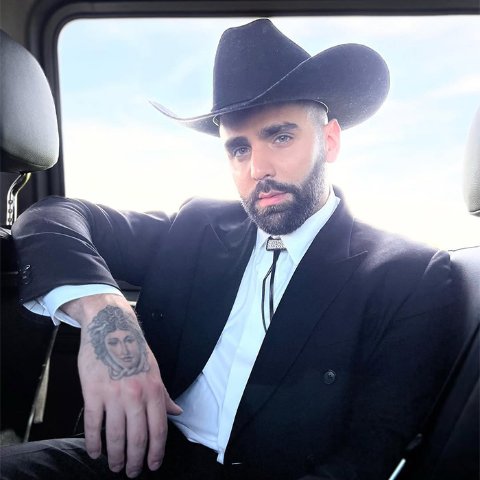 A man in a cowboy hat and suit, representing a modern aesthetic, possibly part of Playboy's rebranding. A man in a cowboy hat and suit, representing a modern aesthetic, possibly part of Playboy's rebranding.