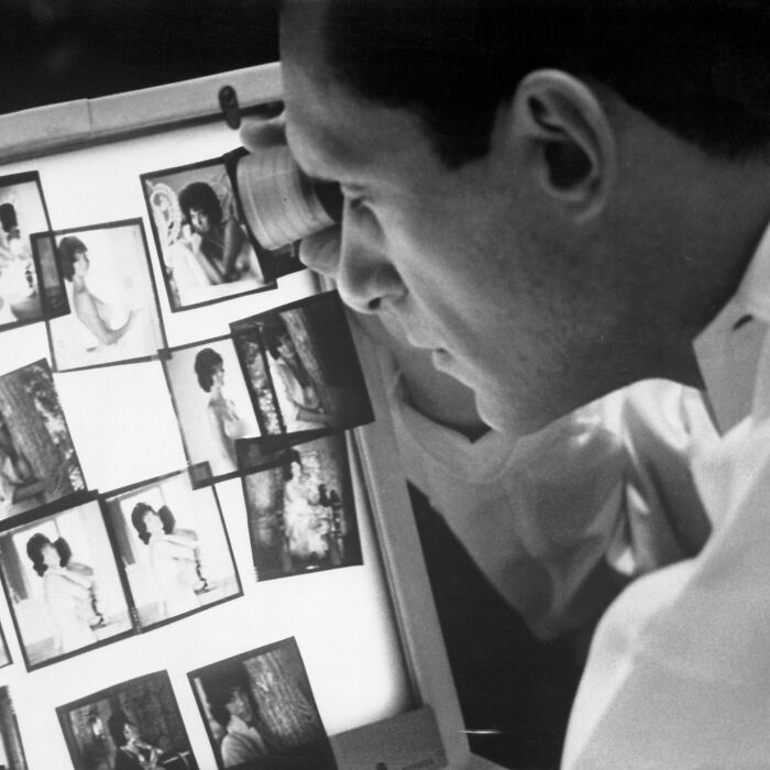 A man reviews Playboy bunnies photos for rebranding and makeover. A man reviews Playboy bunnies photos for rebranding and makeover.