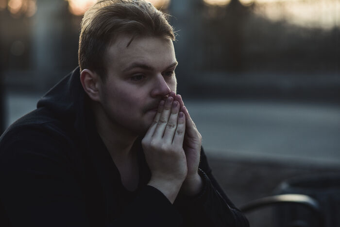 A thoughtful man, reflecting on subtle signs someone isn't as nice as they pretend to be.